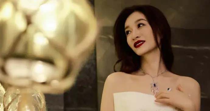 被49岁李小冉的新造型惊艳！一袭白色抹胸裙长卷发，美出新高度！