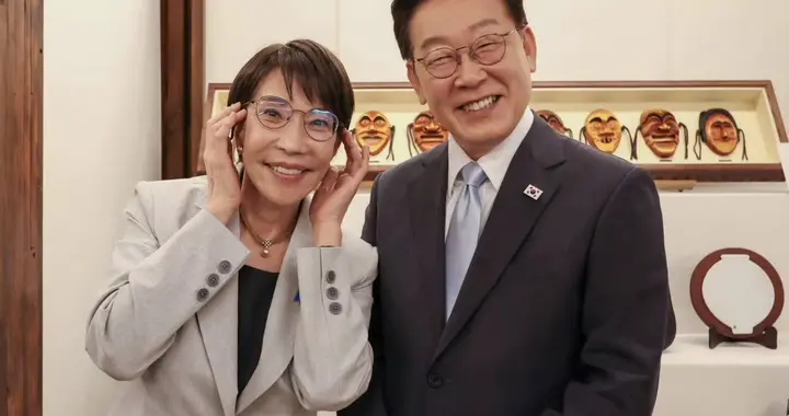 高市早苗想带李在明泡温泉，还送了新眼镜，合影背后写了“火”字