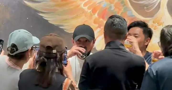 文章在自己上海新开餐馆热情招呼客人，与客人大方合影，帅气友好