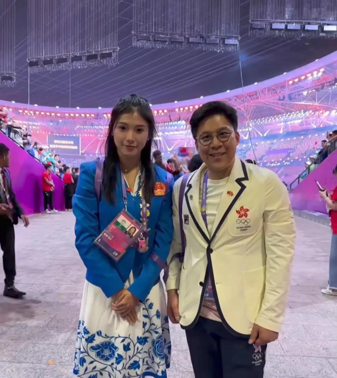 吴艳妮晒出亚运会开幕式现场与霍启刚的合影，看到两个人的手臂貌似被丝带绑在一起，再