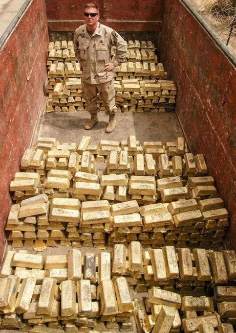 萨达姆的黄金流向了哪里？
图片中的一名美国士兵站在一辆卡车上，装载着从萨达姆·侯