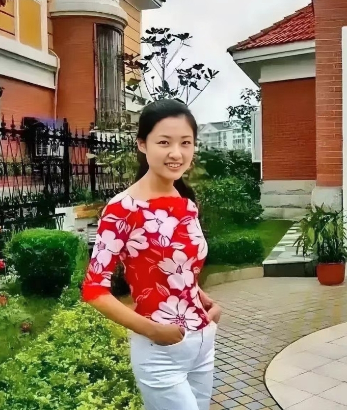 1993年，25岁的周涛站在自家门前留下的珍贵照片。镜头下的她衣着朴素，双手插兜