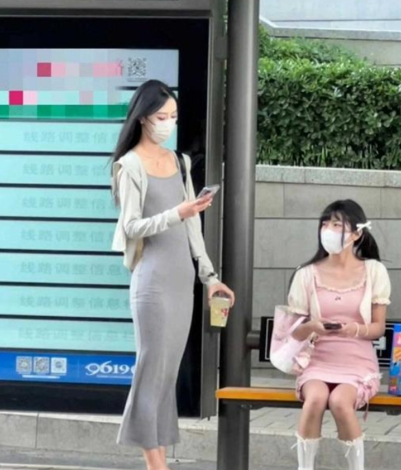 公交车站旁边的看到的~好像是妈妈领女儿出去玩