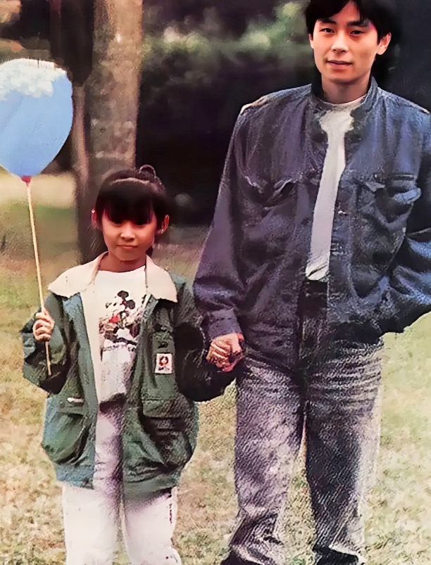 港台地区知名歌手演员王杰与女儿王筱翠的合影。镜头下的王杰身穿牛仔外套配牛仔裤，一