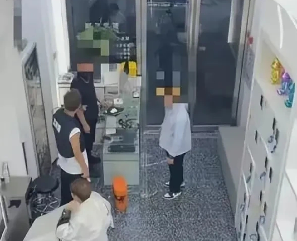 广东广州，男子到理发店剪头发，理发师正在忙，他觉得无聊，随手拿起台子上一把精致的