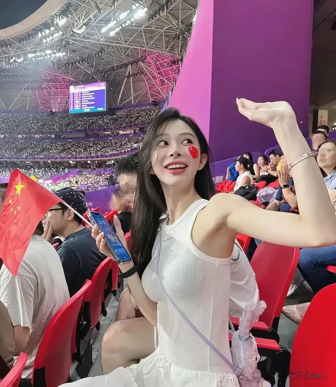 观众席上坐的大美女，真养眼！ 照片中的美女，身穿白色的短衫和短裤，披肩的头发，白