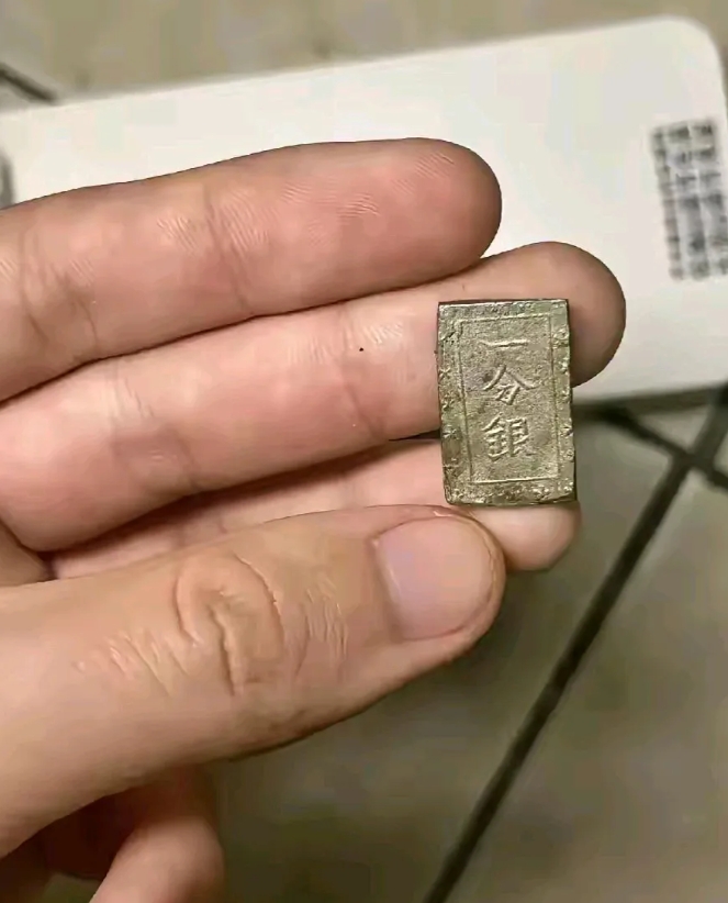 在家里收拾屋子的时候，意外在一个柜子底下翻出来一个小物件，上面还写着“一分银”，