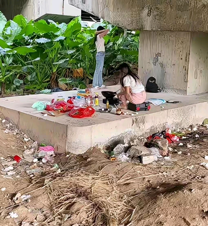桥底下发现漂亮的两个流浪女孩在炒菜。看着她炒菜出来的香气，搞的我口水都流出来了。