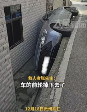 贵州铜仁，女子开车时不慎将前轮掉入侧沟，女子见状有些紧张，本想把车倒出来时，不料
