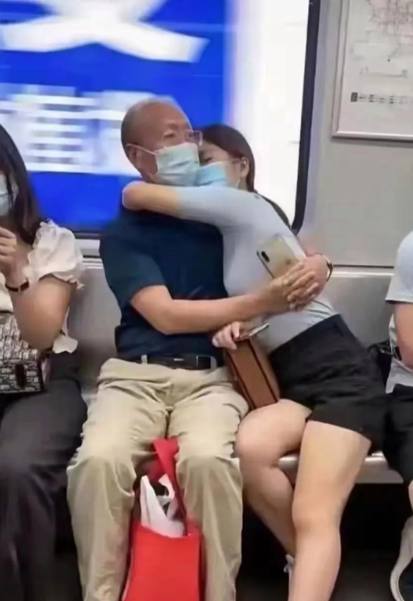 地铁车箱里一位妙龄少女搂着一位七十多岁的老大爷睡着了还是在撒娇？猜猜看他们是什么