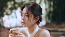 赵今麦身着一袭白色挂颈露肩短裙，如晨雾中初绽的栀子，清丽而脱俗