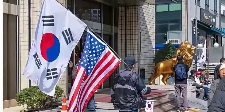 韩国民众拿着美国🇺🇸的国旗举行反华游行，其中有一个游行者刚好碰到去韩国旅游的