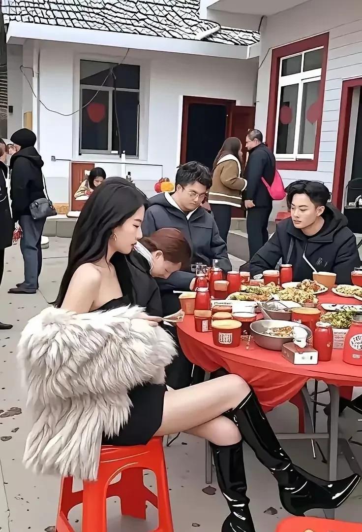 照片中这个姑娘，看起来要比村里的小伙伴们高级很多呀。
无论是穿着还是气质，他们的