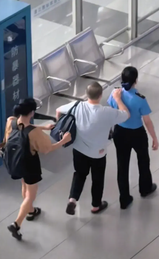 要检票进站了，候车室里，一对盲人父女有些慌乱地四下张望着，一名女工作人员发现后，