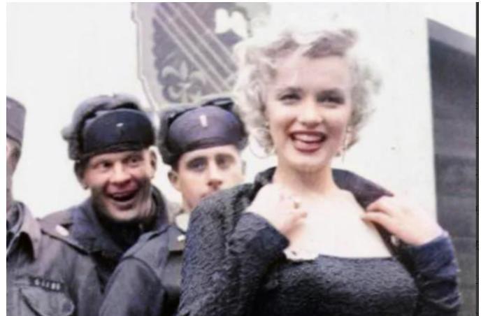 1940年代，一名士兵举起一名年轻的女人，将她送给卡车上的大兵。这名大兵不但亲吻