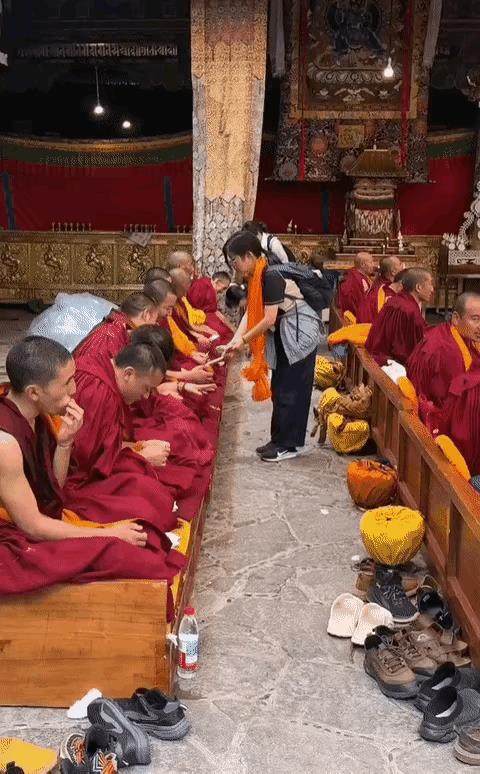 视频中，布施的香客走到一个个僧人面前，低头哈腰给他们发钱，虔诚的像个仆人。而化缘