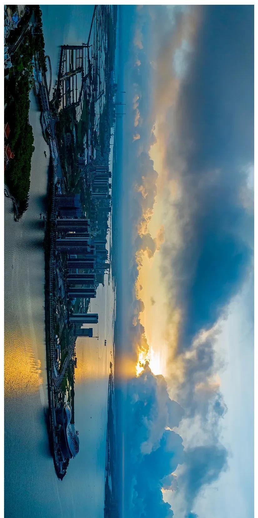 乌云飘忽晓霞红，
日出穿云半露容。
小岛新楼晨光浴，
海湾朝气静且浓。
摄于广东