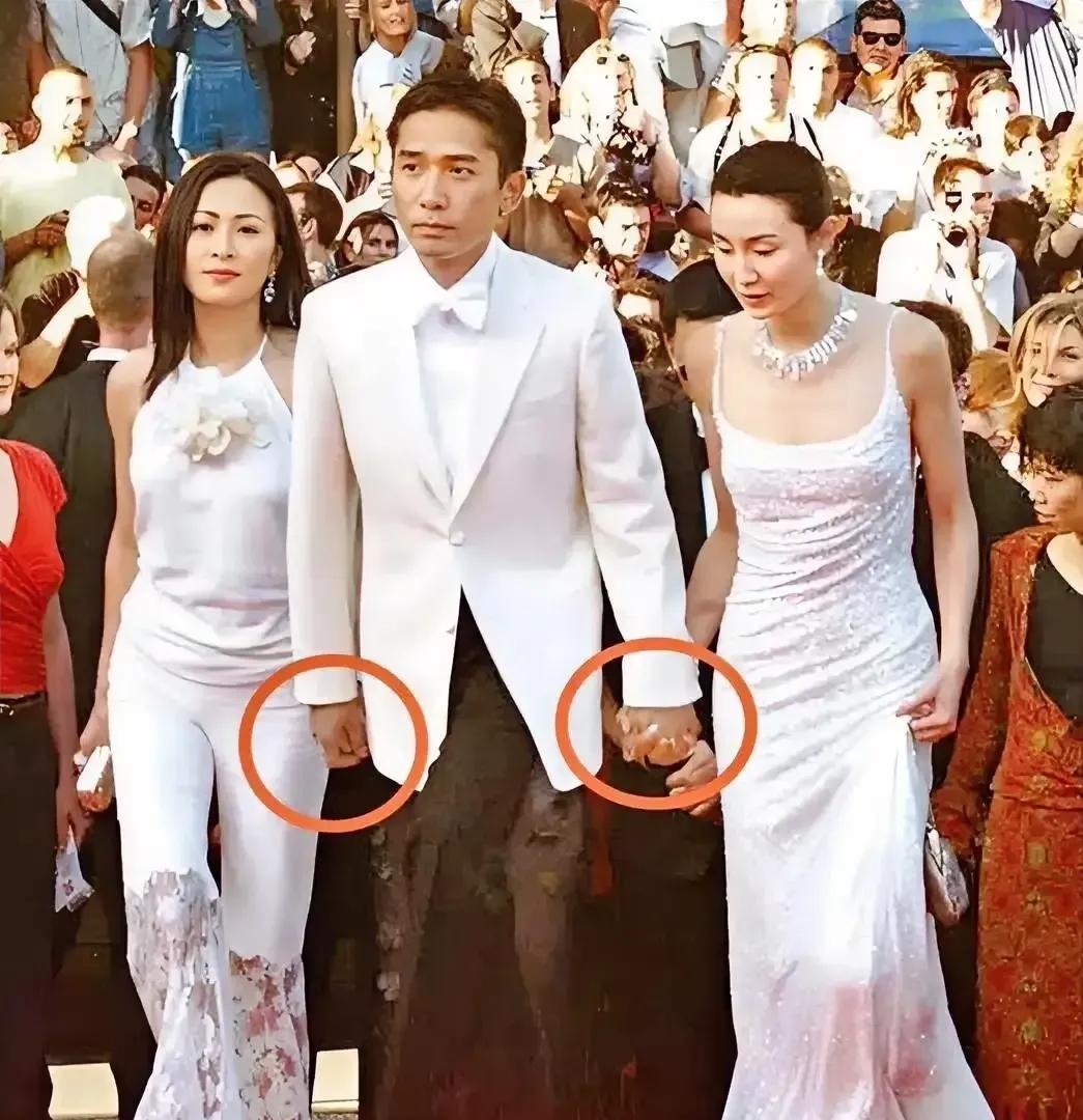 梁朝伟左边的是刘嘉玲，他右边的女士是谁吗？为什么他只是握着老婆刘嘉玲的手，而和右