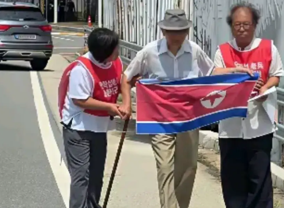朝鲜战争被俘朝鲜士兵安学燮20日手持朝鲜国旗，试图通过板门店返回朝鲜，在京畿道坡