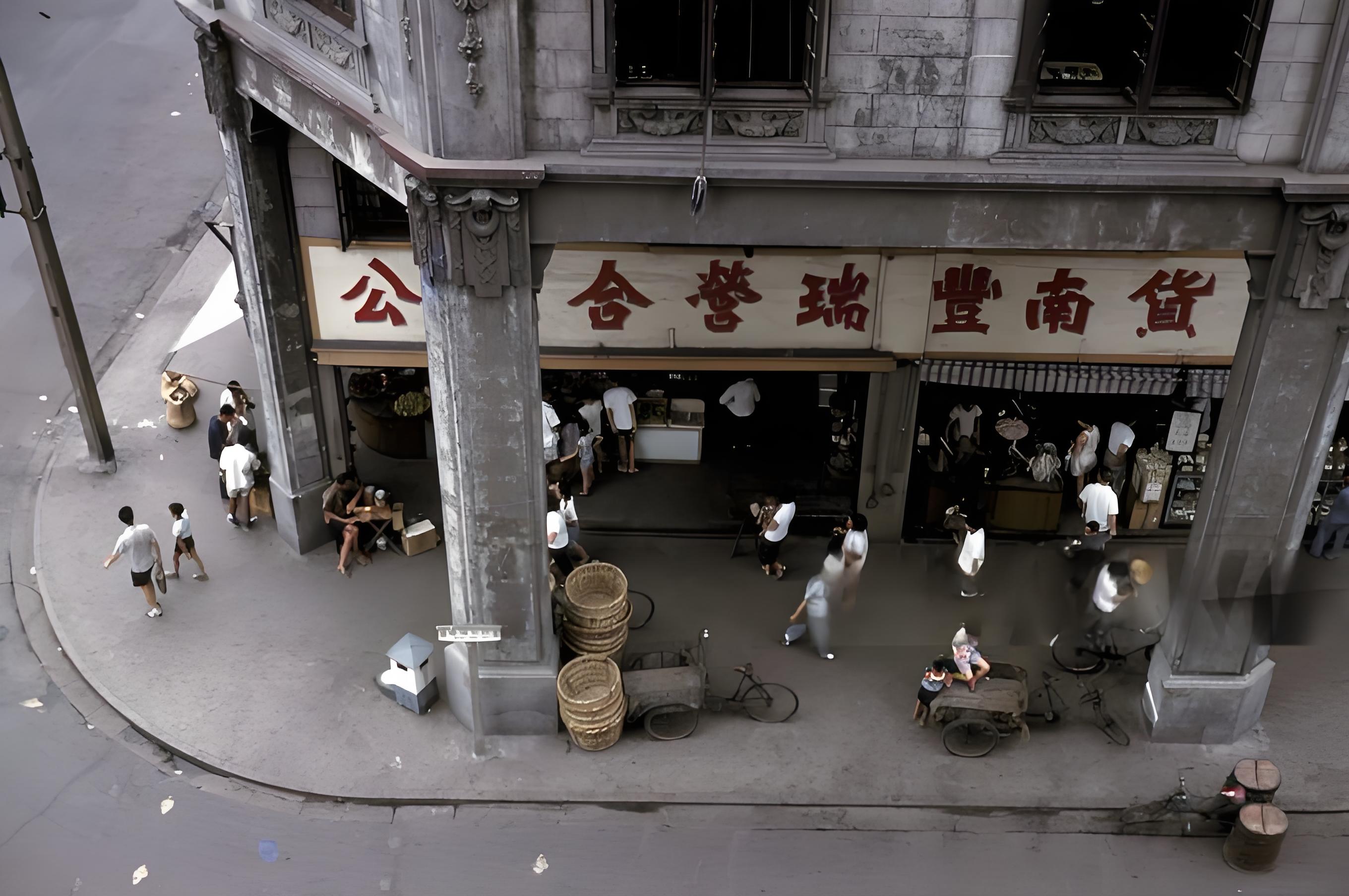 这张照片展现的是新中国初期上海的 “公私合营”的公私合营瑞丰南货商铺，骑楼、石柱