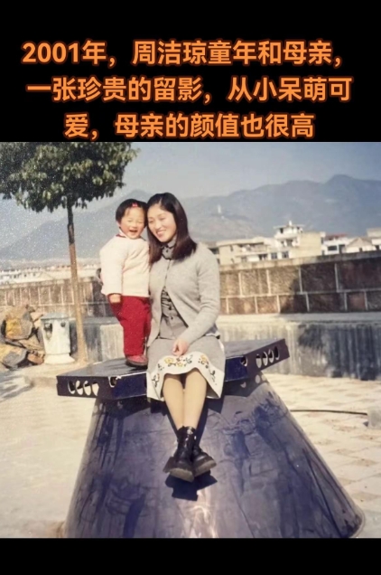 2001年，周洁琼童年和母亲，一张合影。2001年的温馨画面里，年幼的周洁琼依偎