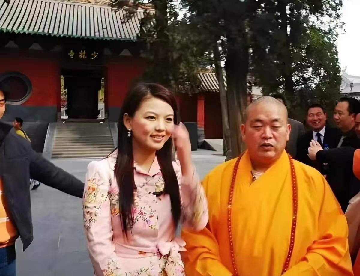 当年李湘去少林寺采访释永信，拍了张照片。那时候湘姐32岁，穿的高跟鞋配粉色短裙，