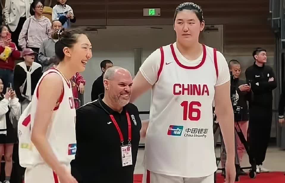 女篮热身赛后，对方教练高兴的和张子宇，韩旭合影。对方球员也跑来合影。哈哈现场气氛