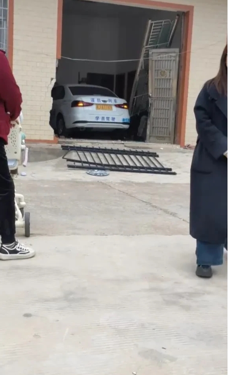 驾校内惊险一幕：女学员开车撞断铁栅栏，又撞进路边房屋[泪奔][泪奔][泪奔]
