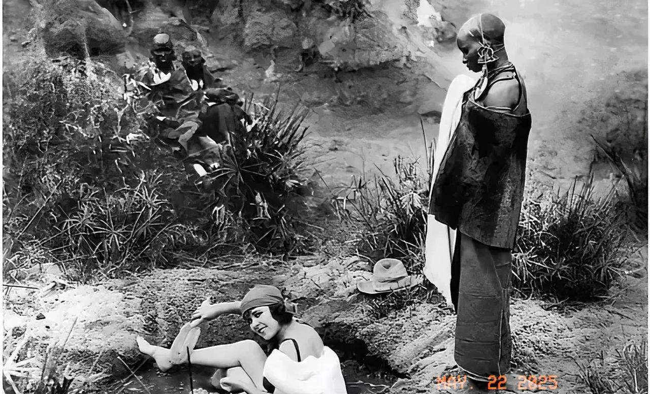 1923年，非洲肯尼亚，一名白人女子在郊外水坑里洗澡。她皮肤白皙光滑，用刷子悠闲