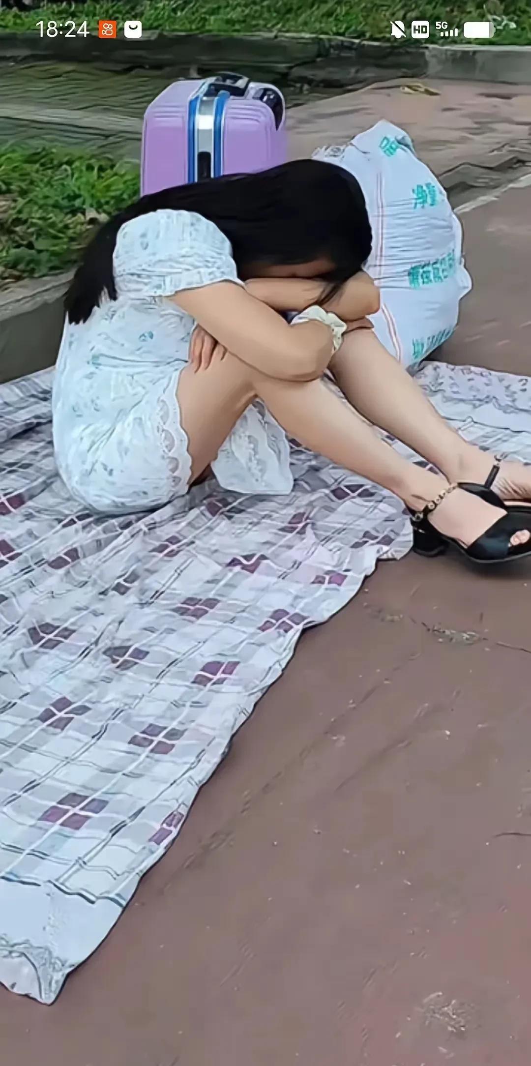 女子独自坐在街头，回不去的家，伤心的蹲在地上哭泣。她遇到了难过的坎？
据说，女的