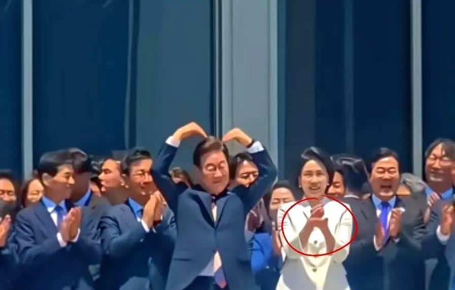 李在明的妻子金惠景今天参加某活动时，做了一个很奇怪的手势，伸出弯曲的食指和中指，
