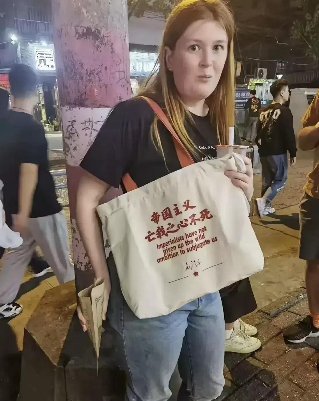 昨晚在小吃街上，看到一名外国女子买了一个国产的帆布包。上面印着伟人语录，“帝国主