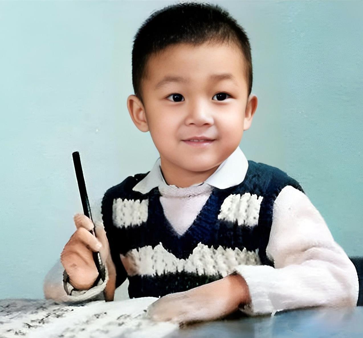 这个手持毛笔，秀气可爱的小男孩正是后来成为大明星的潘粤明。潘粤明1974年出生于