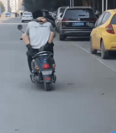 真是林子大了什么鸟都有，一对男女边骑车边搂抱亲吻，非常投入，车子在路上摇摇晃晃，