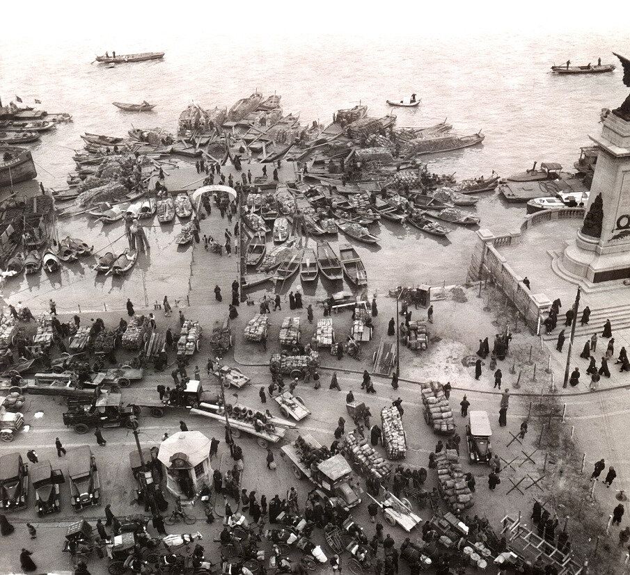 1930年上海港口码头，河面挤满大小木船，船只满载货物停靠滩岸。 