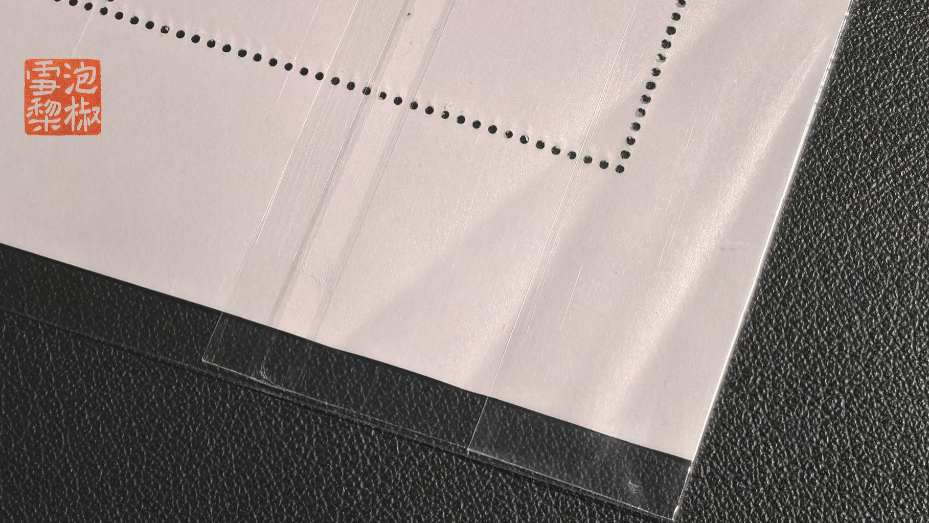 是保护还是故意破坏？总公司给整版邮票套了个袋，结果满是折痕