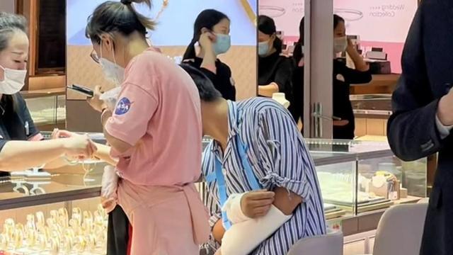 男子打着石膏陪老婆去买首饰，网友：你猜他的胳膊是怎么断的