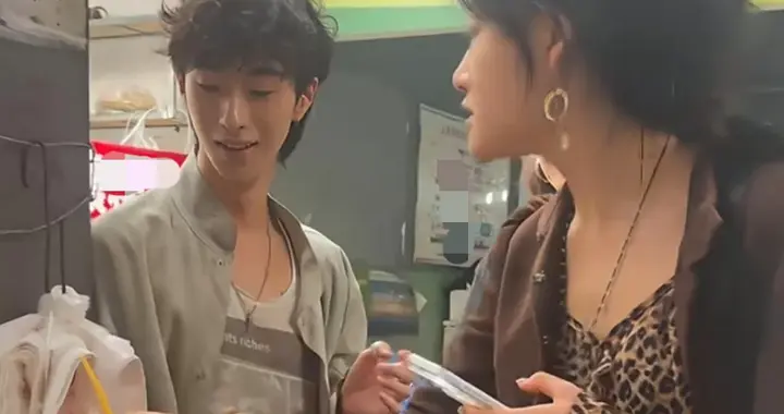 伊能静23岁儿子恩利现身四川旅游，他到路边摊买小吃，面相怪怪的