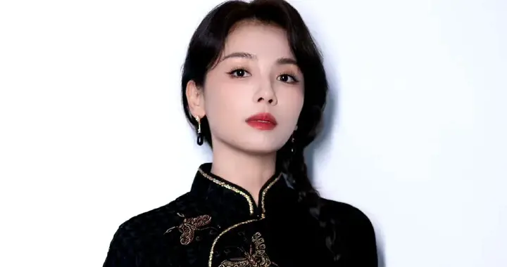 刘涛一袭带有金色刺绣与镶边的黑色旗袍，长发编辫，妆容精致