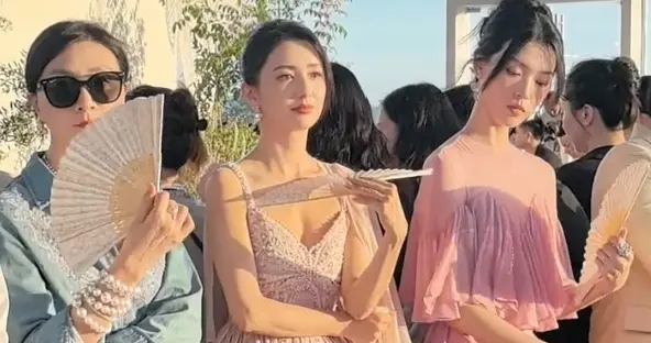 佟丽娅出席活动，身穿藕粉长裙，折扇轻扇，优雅美丽