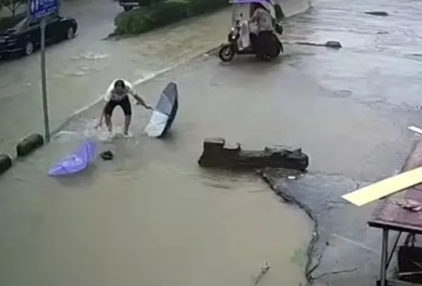?天天正能量官方|暴雨中背书包女孩被暗坑吞没，他们为救人连鞋都跑丢了……英雄现身了！