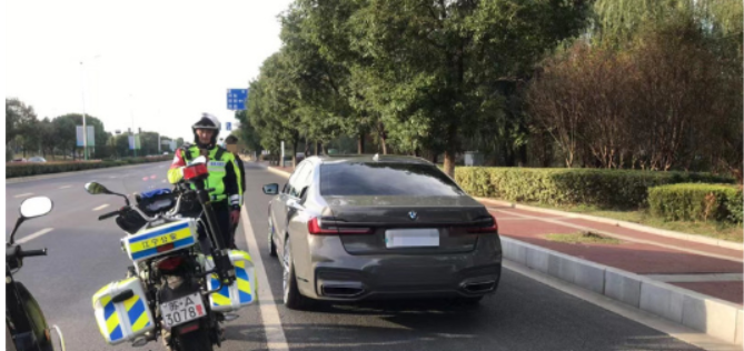男子违停还用塑料板遮挡号牌,没想到全程被骑警看到了