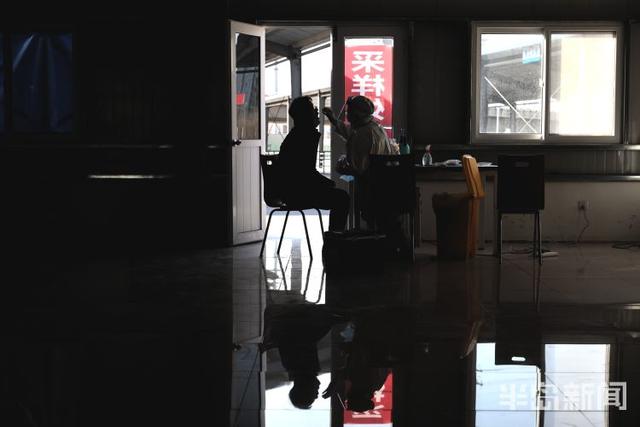 半岛新闻客户端 核酸采样点设在务工市场，为返乡人员提供便利