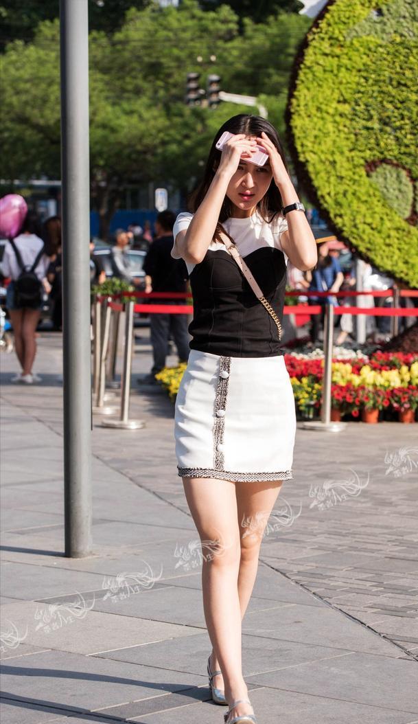 回顾女子穿着独特细绳缠腰，不在意路人拍照，对着镜头自信的微笑