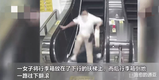 浙江杭州,一地铁进站口,一女子带着两个行李箱进站