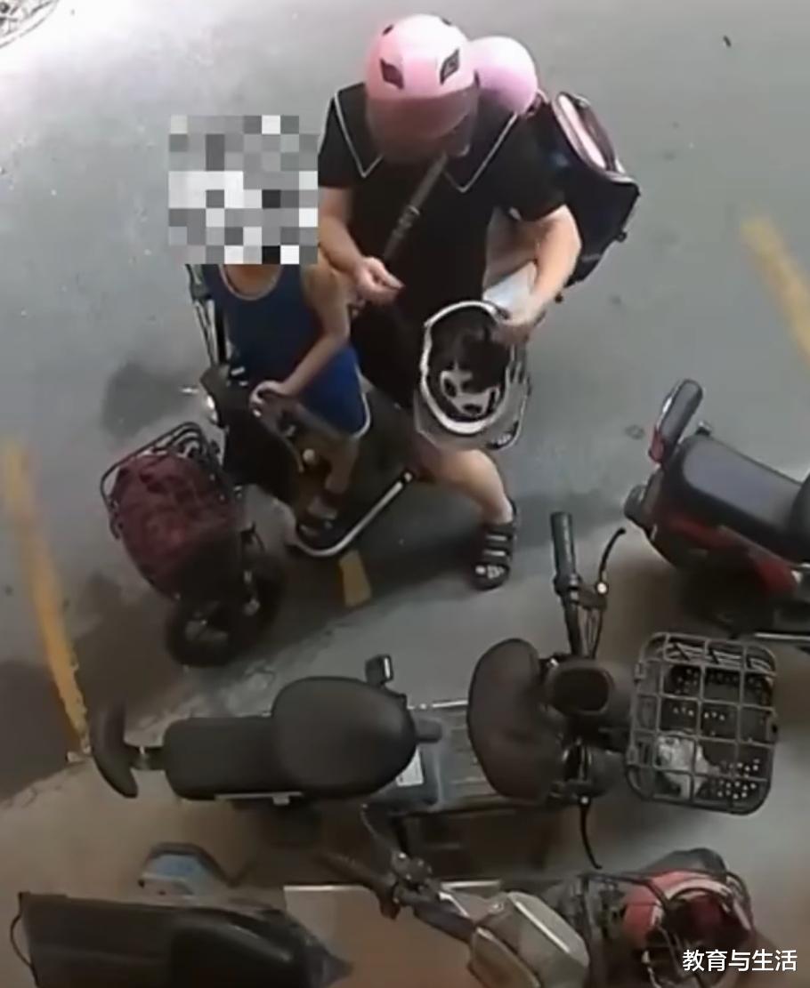 女子骑电动车带儿女出行偷路边电动车头盔给儿子带来主人报案,女子:为20元钱报案,太可笑了