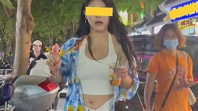 女子在夜市上吃饱后，解开裤腰的扣子继续吃