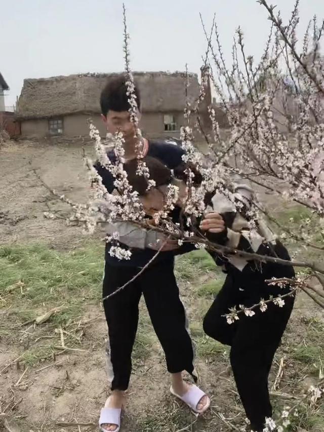 男子要外出打工,可是女友却不愿同行,两人在桃树下告别