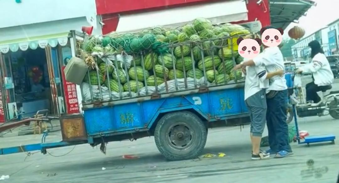 男子带着女友在街头卖瓜,两个人只顾甜蜜,顾客秒变吃瓜群众