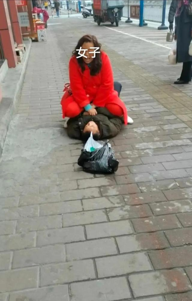 长沙街头,女子把男子按倒在地不让走要男子还钱。男子挣扎了好一会都没能够翻身
